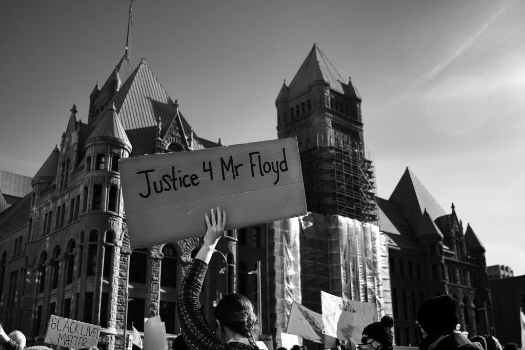 A person holds a Justice 4 Mr Floyd sign outside City Hall in downtown Minneapolis, Minnesota as the trial of former Minneapolis police officer Derek Chauvin began Monday morning